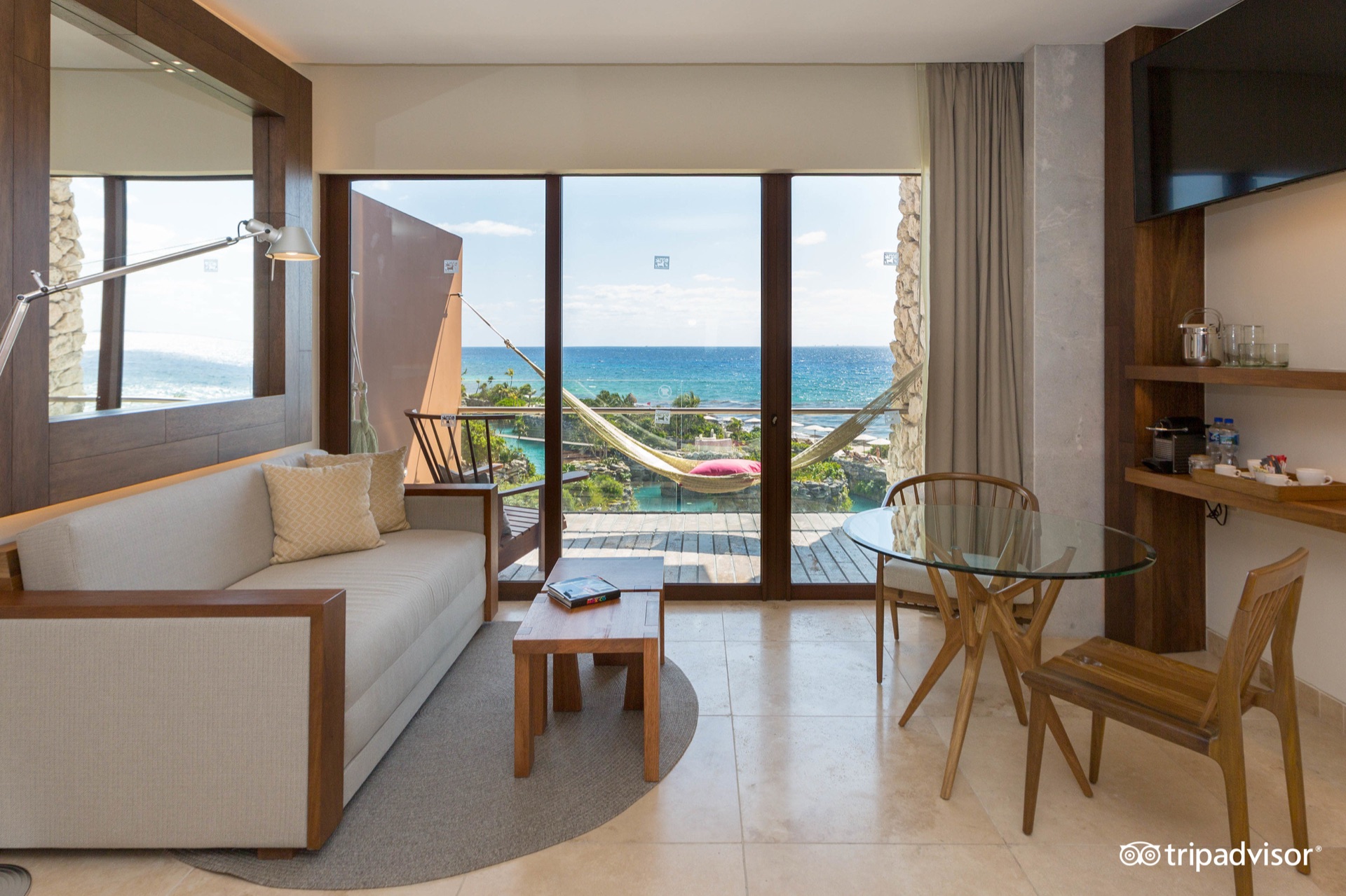 Oceanview terrace at Hotel Xcaret Mexico overlooking the turquoise Caribbean, a backdrop for a larger destination-wedding reception